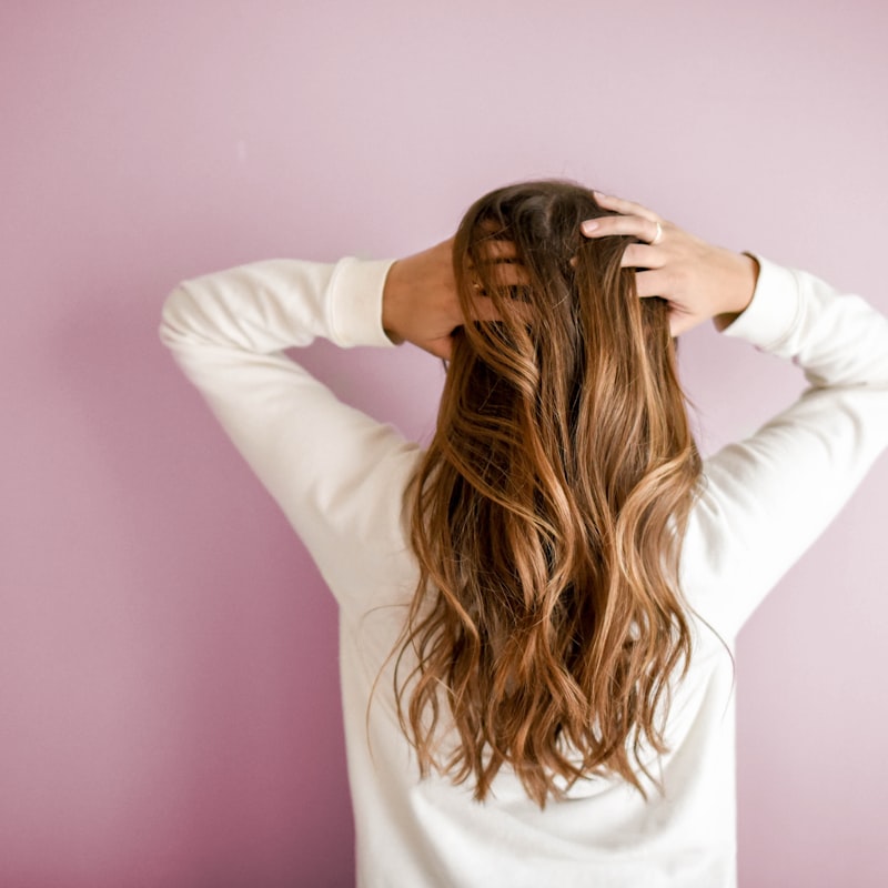 Stylist working on client hair in salon studio